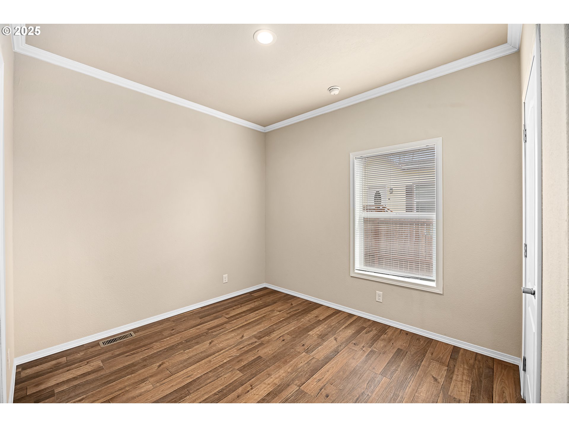 352 North Falcon Street Rockaway Beach, OR 97136 - Photo 19 of 32 a view of an empty room with wooden floor and a window