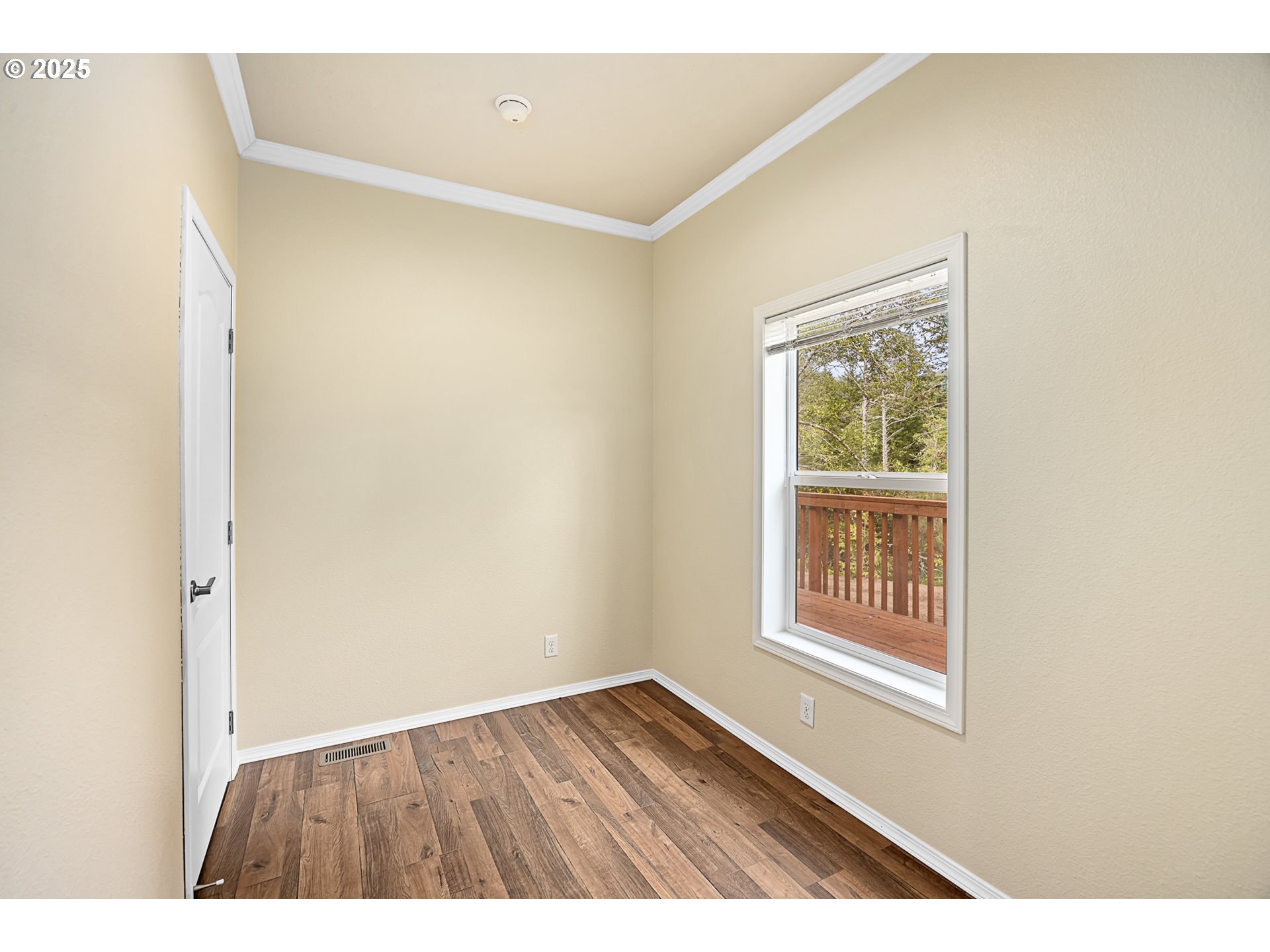 352 North Falcon Street Rockaway Beach, OR 97136 - Photo 23 of 32 a view of an empty room with wooden floor and a window