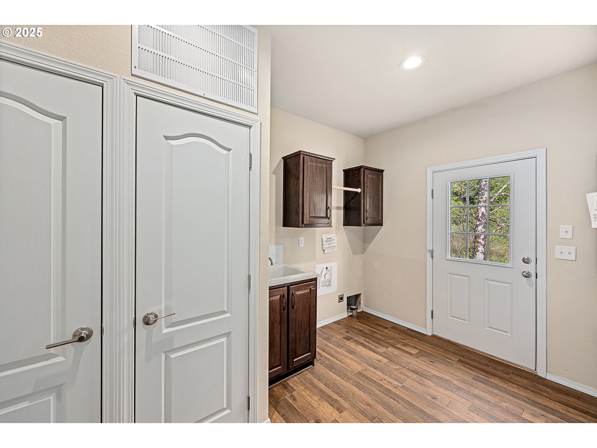 352 North Falcon Street Rockaway Beach, OR 97136 - Photo 25 of 32 a view of a livingroom with wooden floor and cabinet
