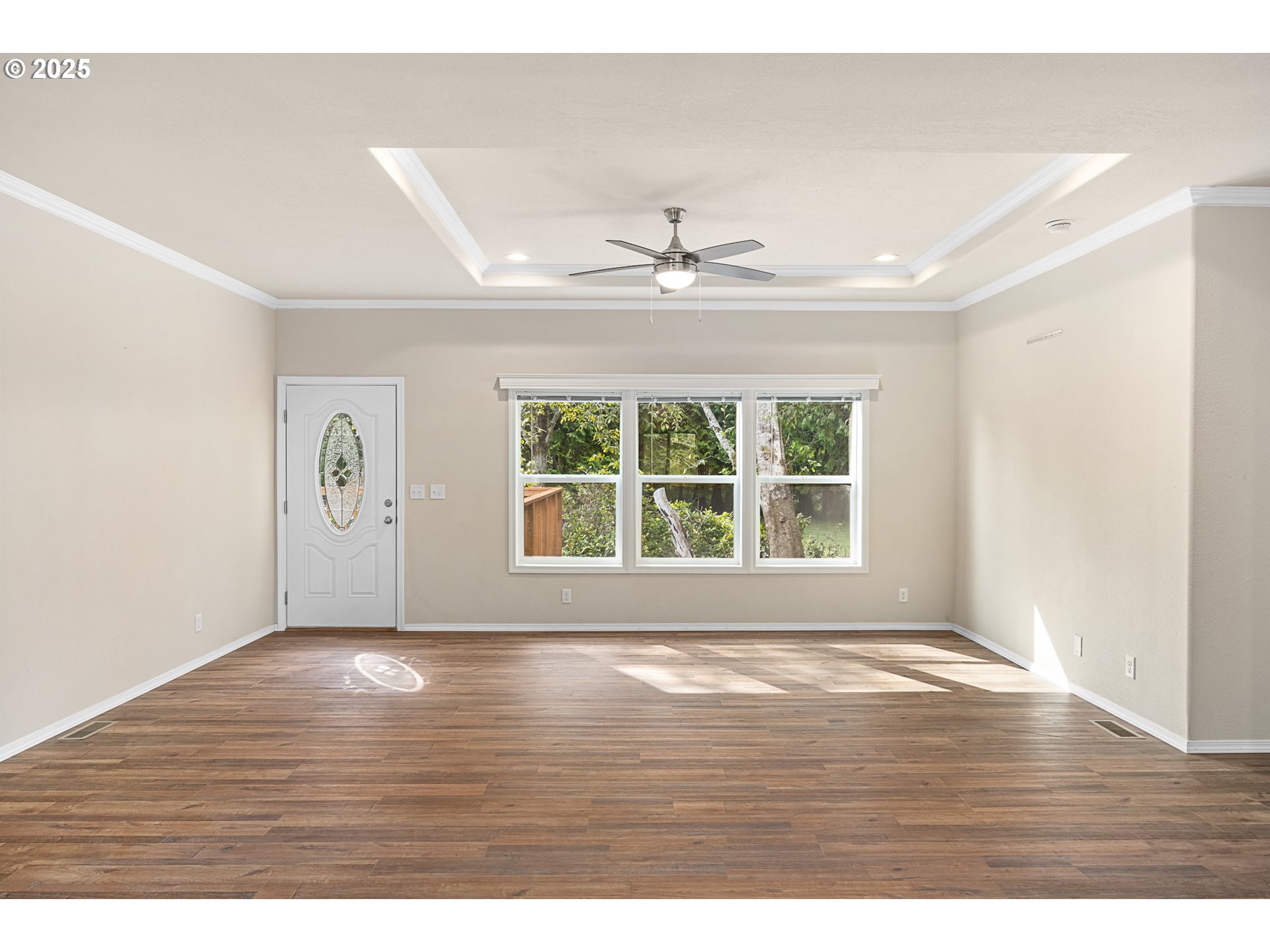 352 North Falcon Street Rockaway Beach, OR 97136 - Photo 5 of 32 a view of an empty room with wooden floor and a window