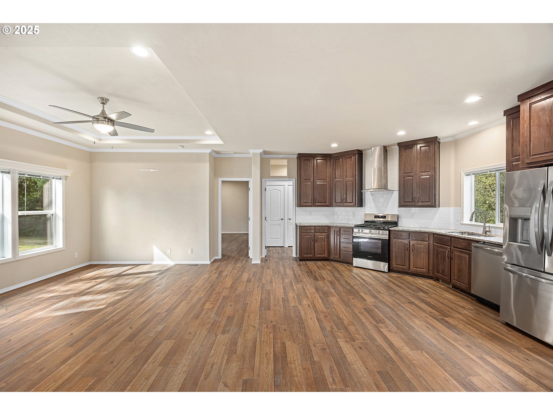 352 North Falcon Street Rockaway Beach, OR 97136 - Photo 9 of 32 a open kitchen with stainless steel appliances refrigerator stove and wooden floor