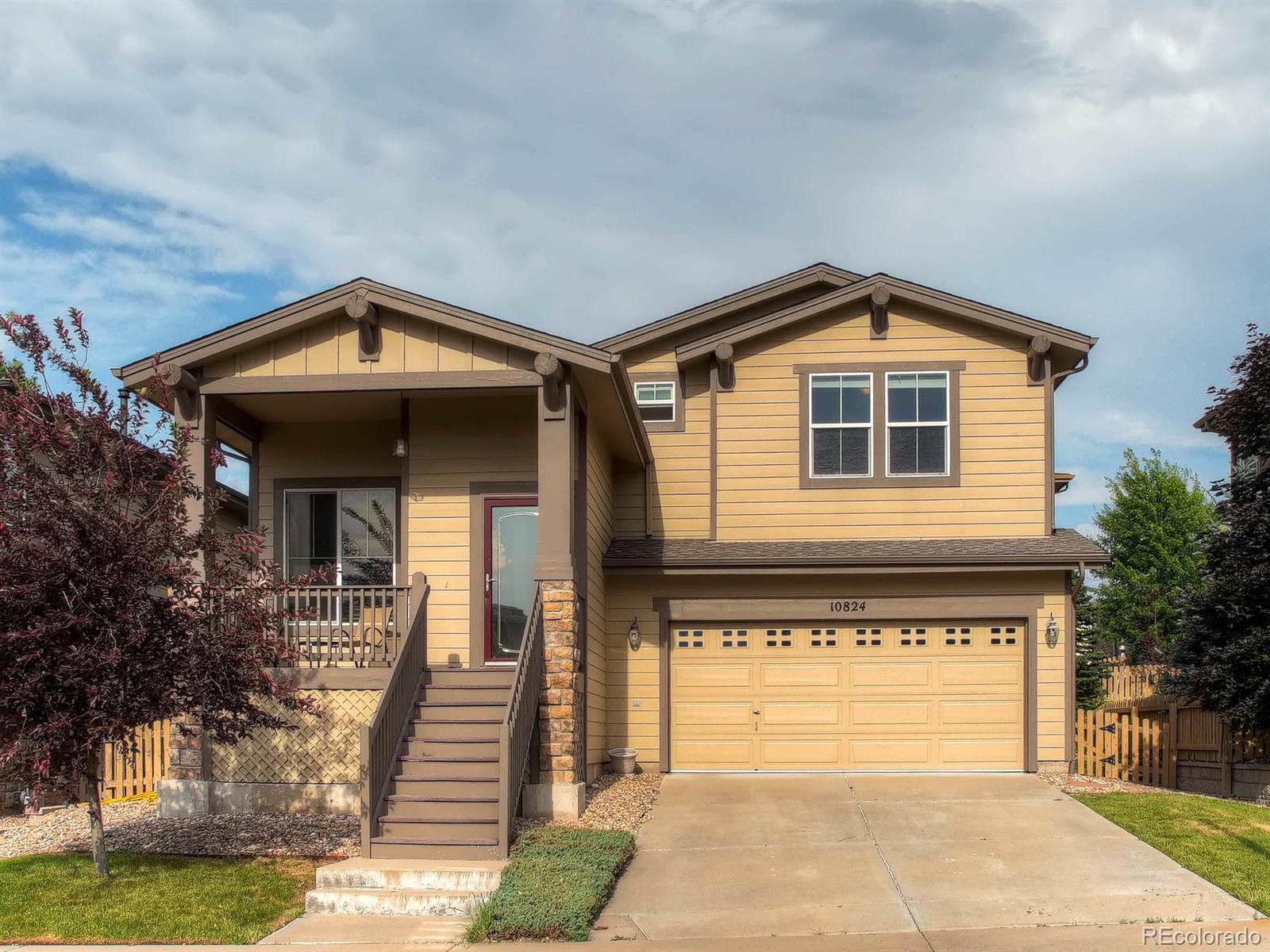 10824 Towerbridge Road Highlands Ranch, CO 80130 - Photo 1 of 33 a front view of a house with a yard