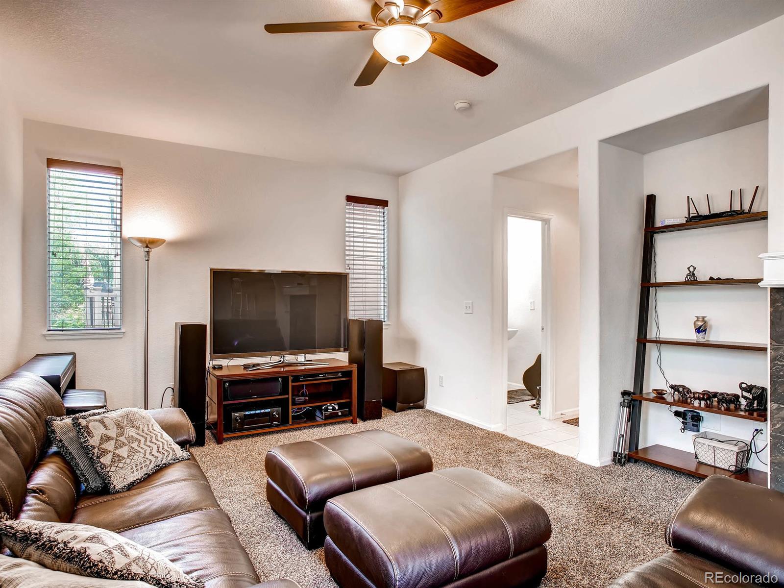 10824 Towerbridge Road Highlands Ranch, CO 80130 - Photo 13 of 33 a living room with furniture and a flat screen tv