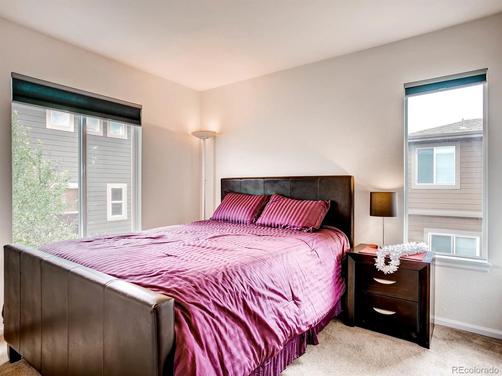 10824 Towerbridge Road Highlands Ranch, CO 80130 - Photo 18 of 33 a bedroom with a bed and a large window