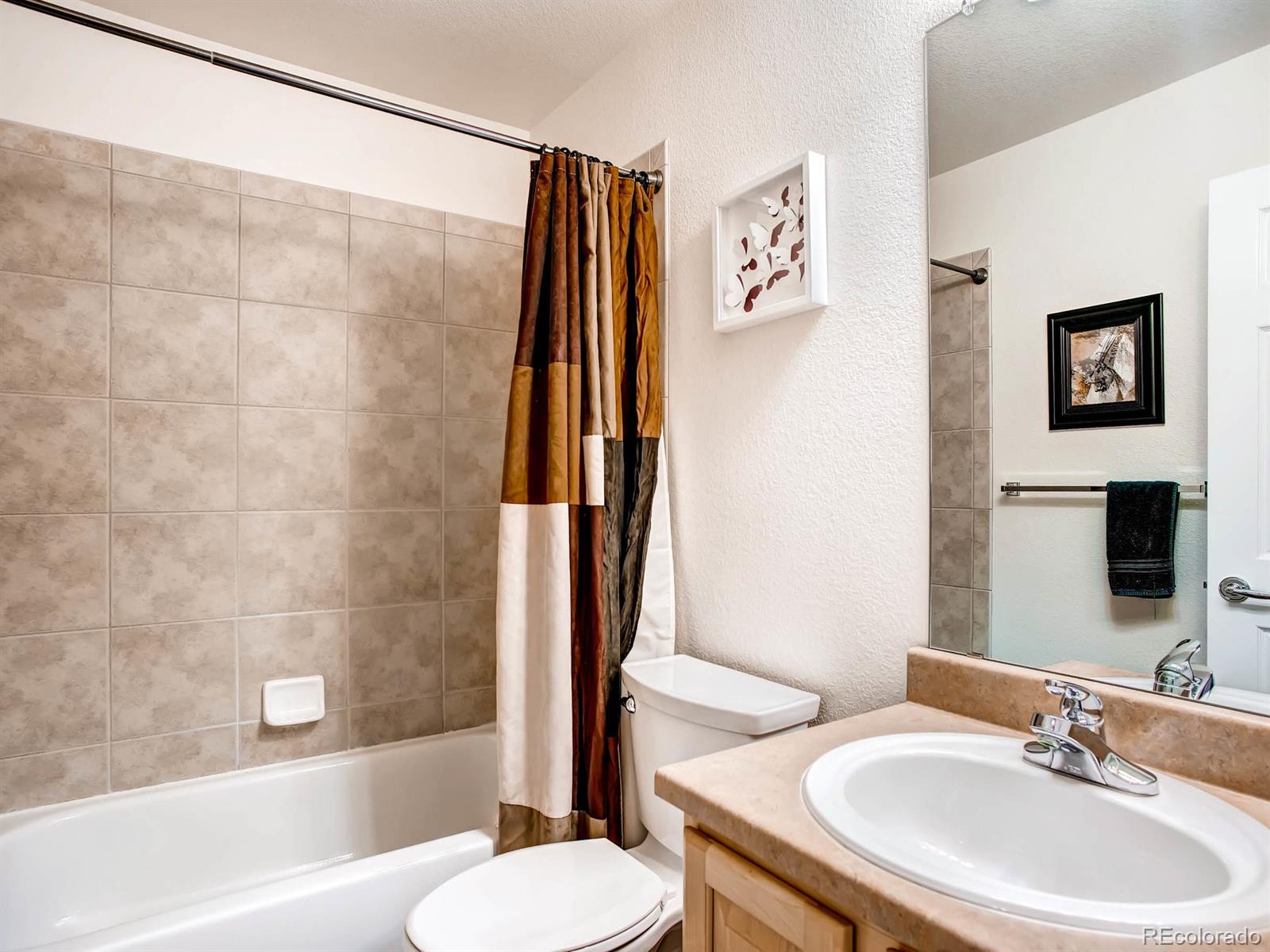 10824 Towerbridge Road Highlands Ranch, CO 80130 - Photo 19 of 33 a bathroom with a sink and a mirror