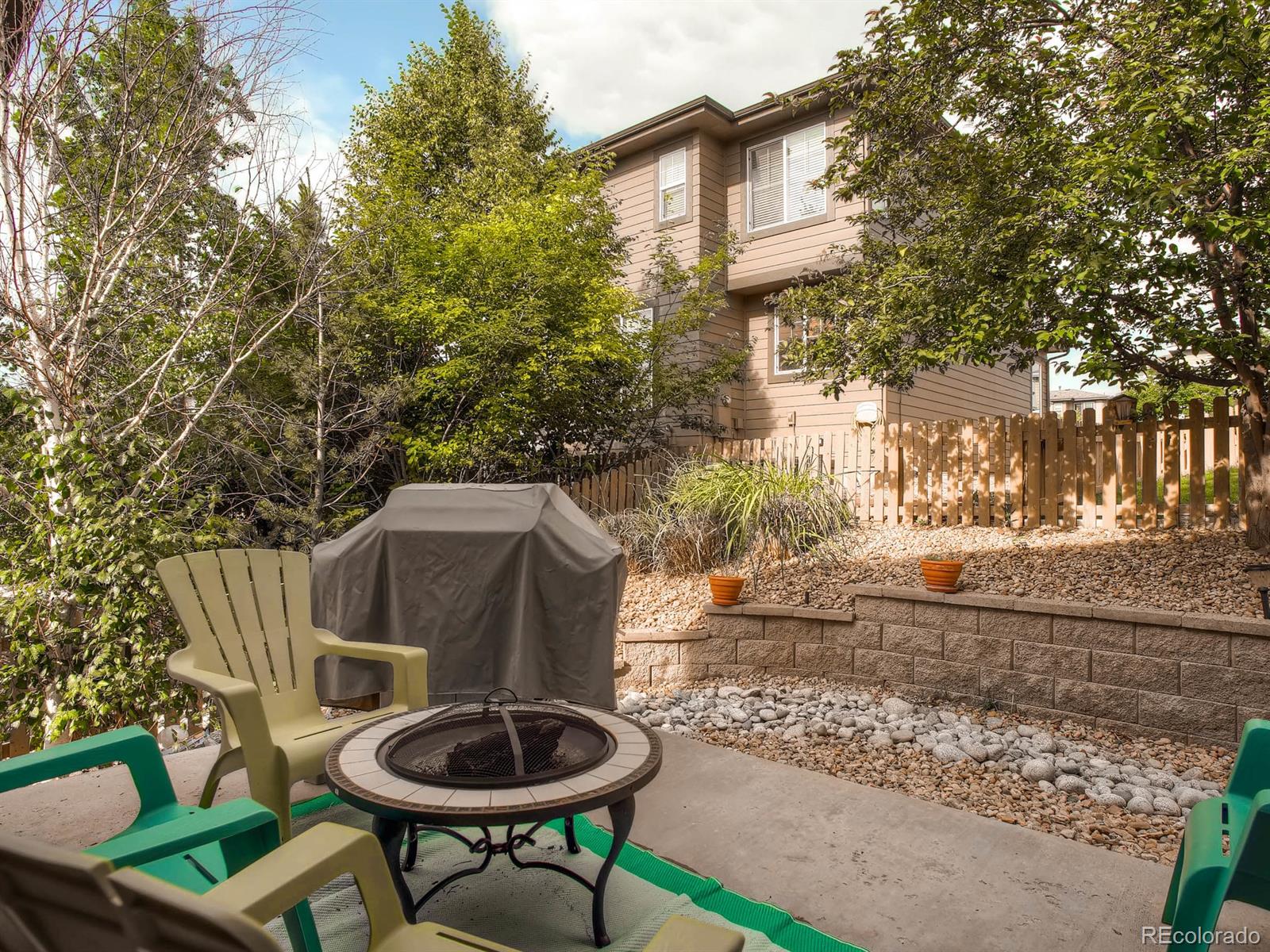 10824 Towerbridge Road Highlands Ranch, CO 80130 - Photo 20 of 33 a backyard of a house with table and chairs