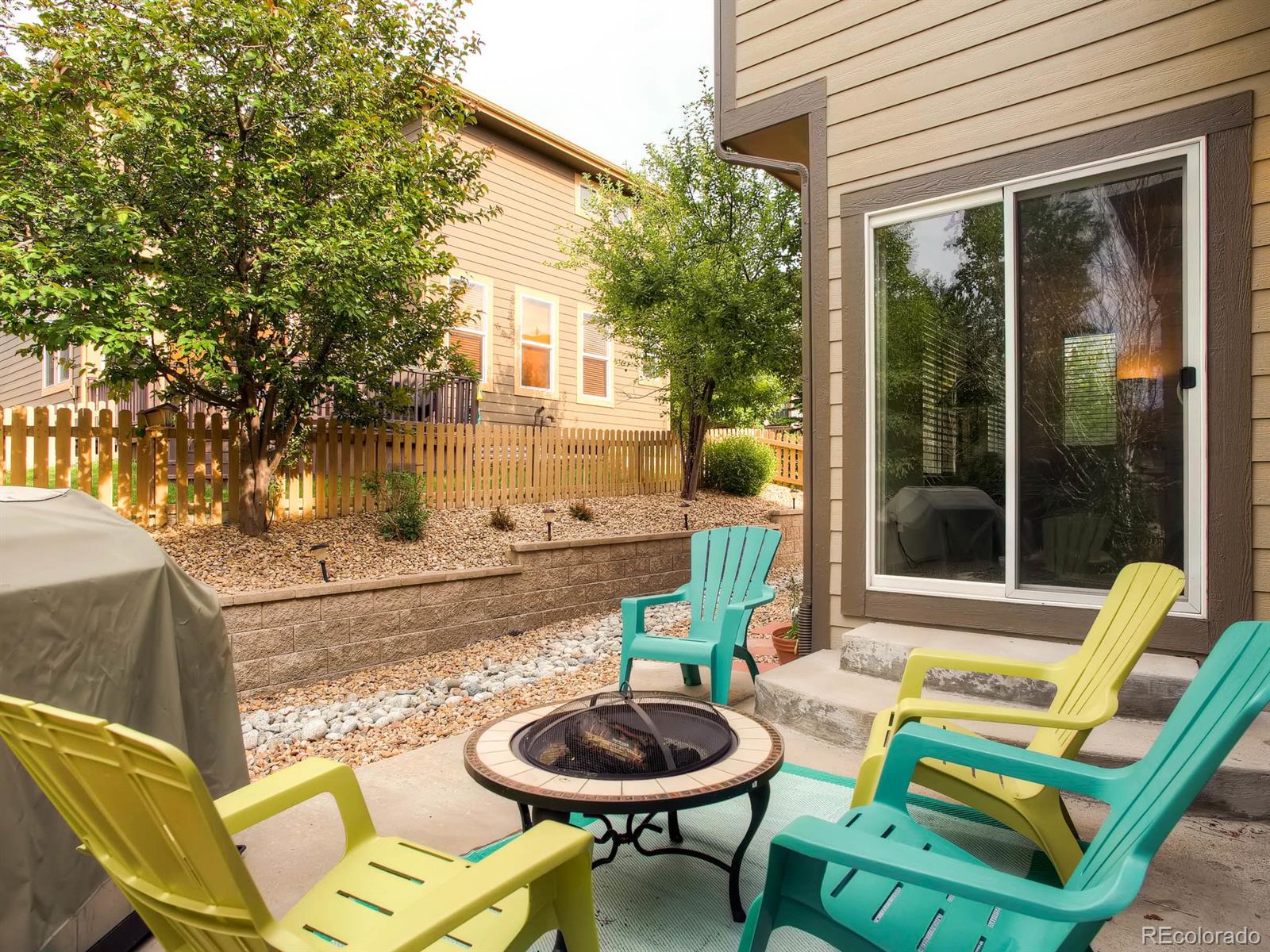 10824 Towerbridge Road Highlands Ranch, CO 80130 - Photo 21 of 33 a view of a chair and table in backyard of the house