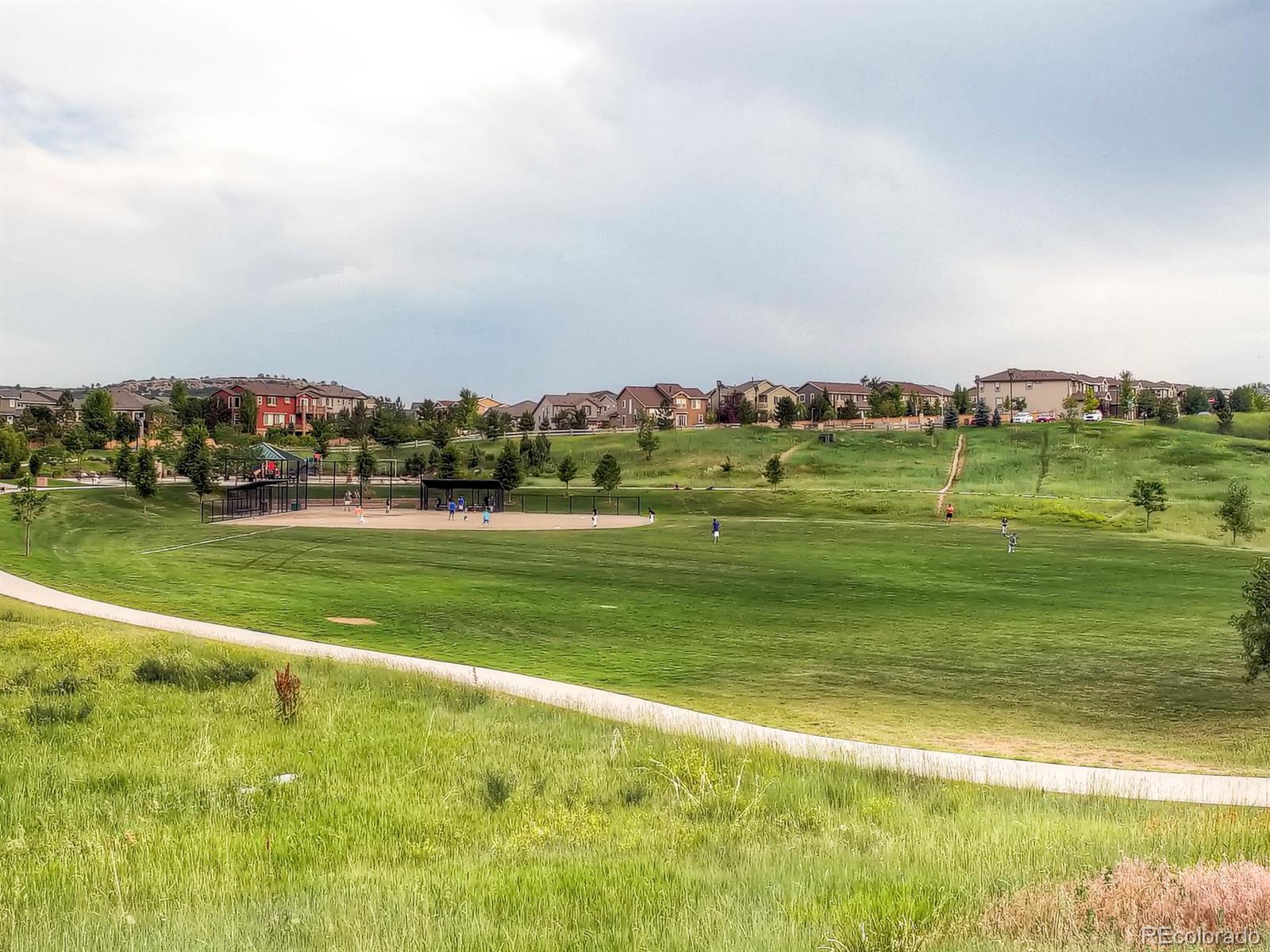 10824 Towerbridge Road Highlands Ranch, CO 80130 - Photo 27 of 33 a view of a golf course with a lake