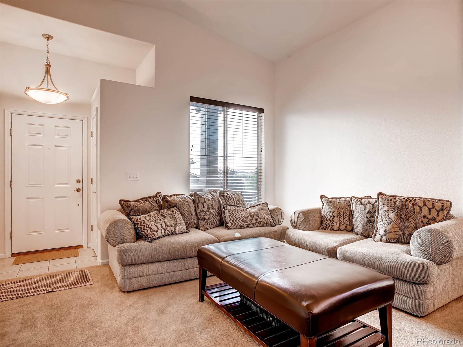 10824 Towerbridge Road Highlands Ranch, CO 80130 - Photo 3 of 33 a living room with furniture and a couch