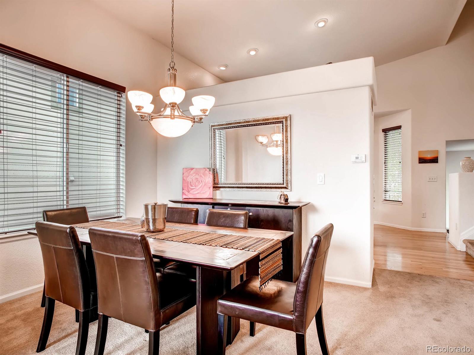 10824 Towerbridge Road Highlands Ranch, CO 80130 - Photo 5 of 33 a view of a dining room with furniture and chandelier