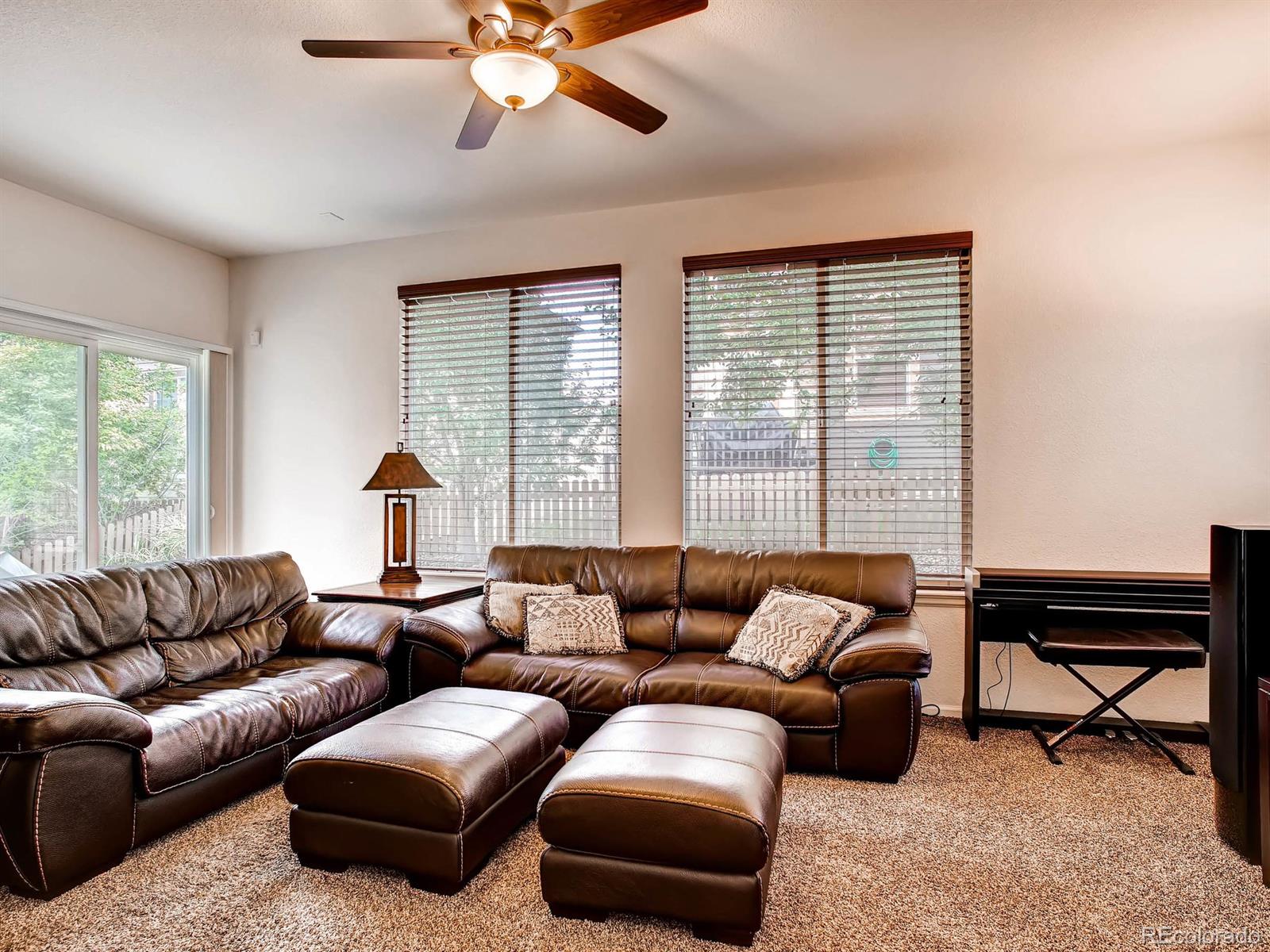 10824 Towerbridge Road Highlands Ranch, CO 80130 - Photo 10 of 33 a living room with furniture and a large window