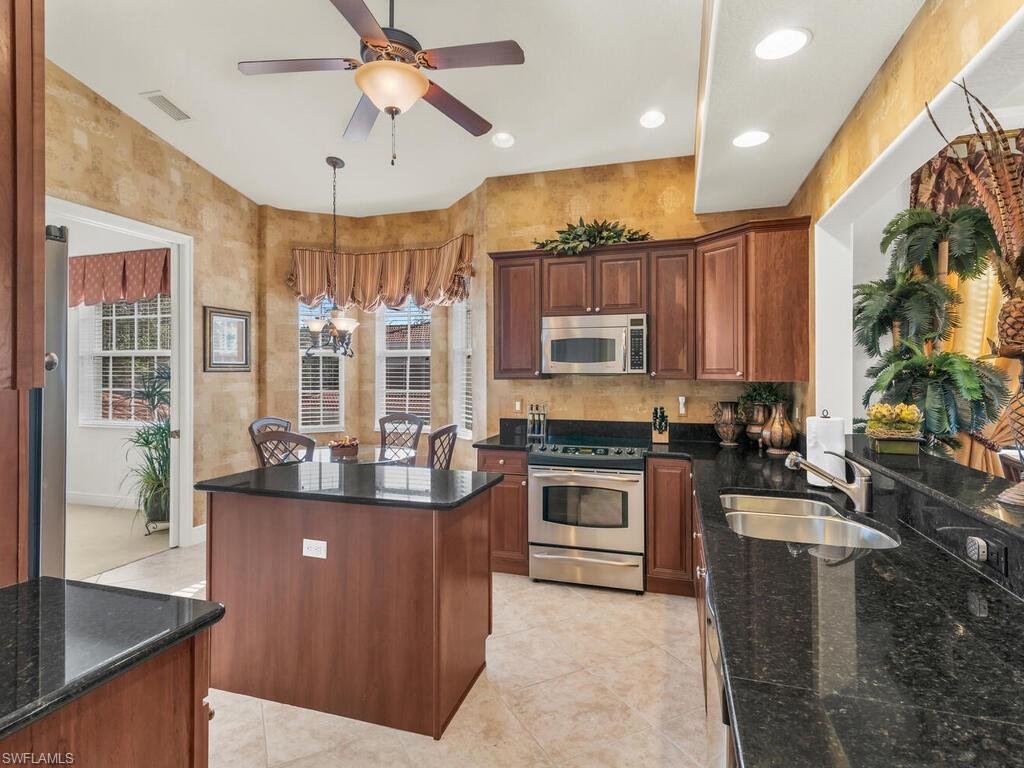 7869 Hawthorne Drive, Unit 303 Naples, FL 34113 - Photo 15 of 50 Kitchen with a wealth of natural light, sink, a center island, and stainless steel appliances