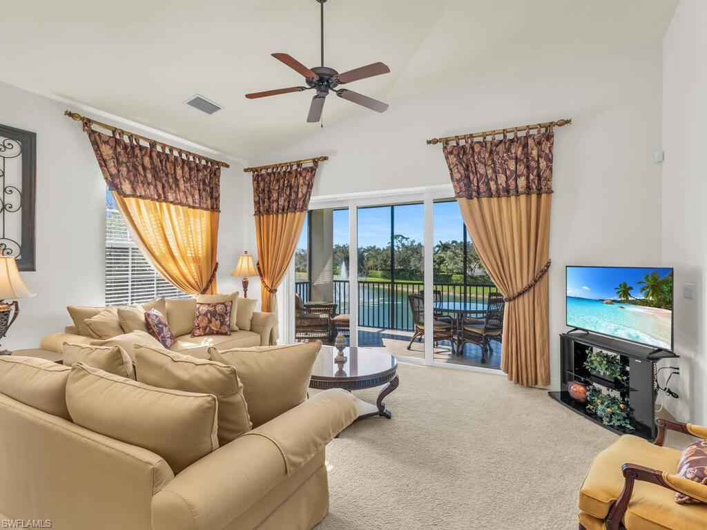 7869 Hawthorne Drive, Unit 303 Naples, FL 34113 - Photo 18 of 50 Carpeted living room with ceiling fan