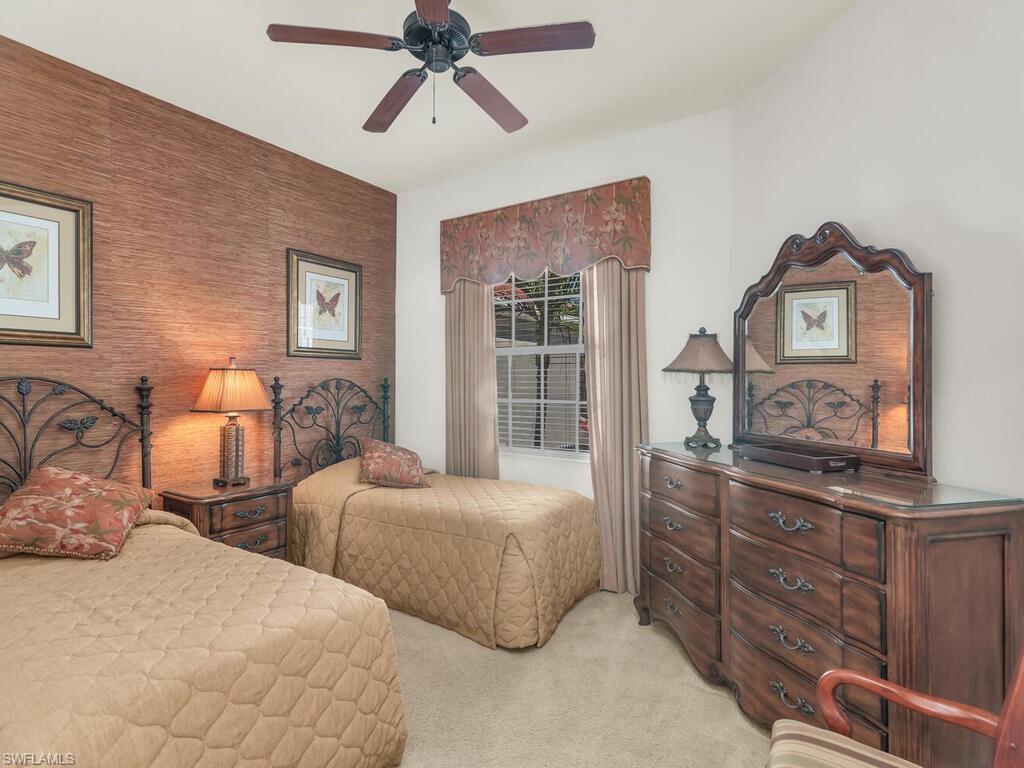7869 Hawthorne Drive, Unit 303 Naples, FL 34113 - Photo 27 of 50 Bedroom with ceiling fan and light colored carpet