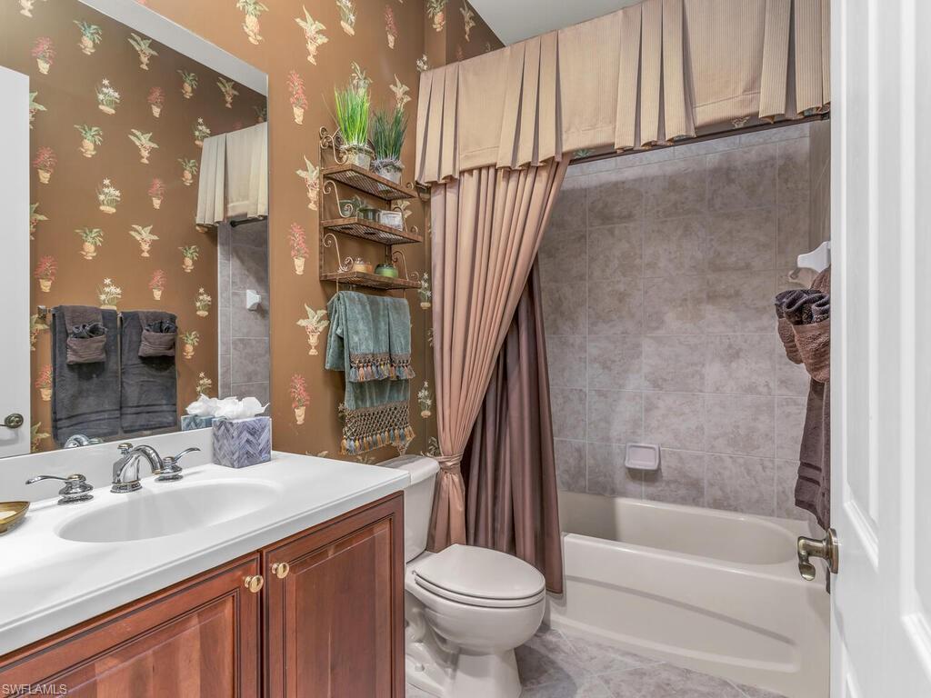 7869 Hawthorne Drive, Unit 303 Naples, FL 34113 - Photo 28 of 50 Full bathroom with shower / bath combo, toilet, and vanity