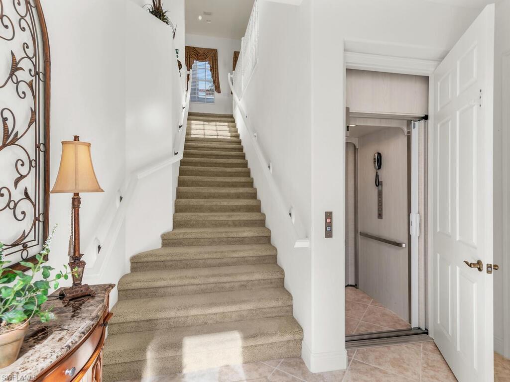 7869 Hawthorne Drive, Unit 303 Naples, FL 34113 - Photo 6 of 50 Stairs with tile patterned floors