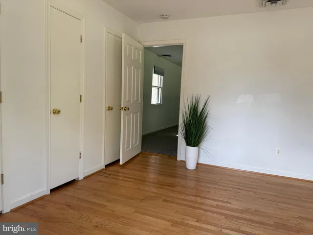 a view of a room with wooden floor and a wall