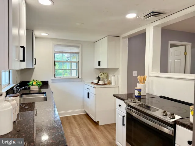 a kitchen with a stove a sink and a refrigerator