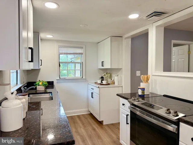a kitchen with a stove a sink and a refrigerator