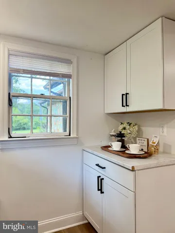 a kitchen with a sink cabinets and window