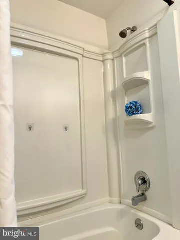 a bathroom with a shower and a sink