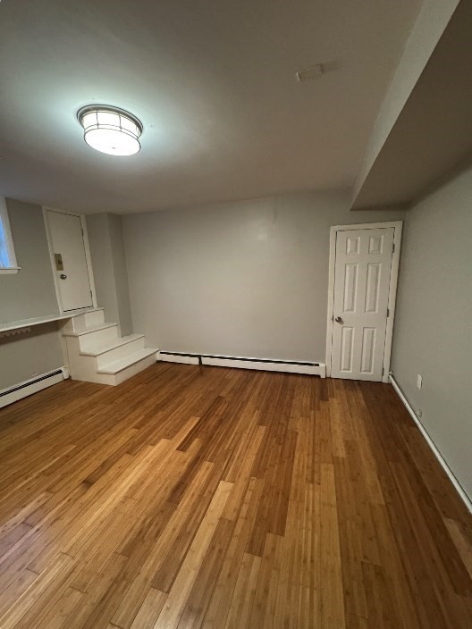 120 Charles Street, Unit 1 Boston, MA 02114 - Photo 2 of 4 an empty room with wooden floor and windows
