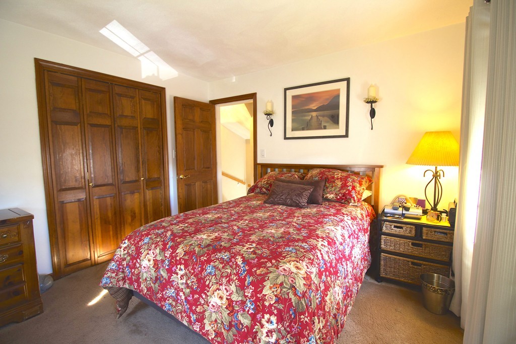 41 Lodge Road Newton, MA 02465 - Photo 14 of 25 a bedroom with a bed and wooden floor