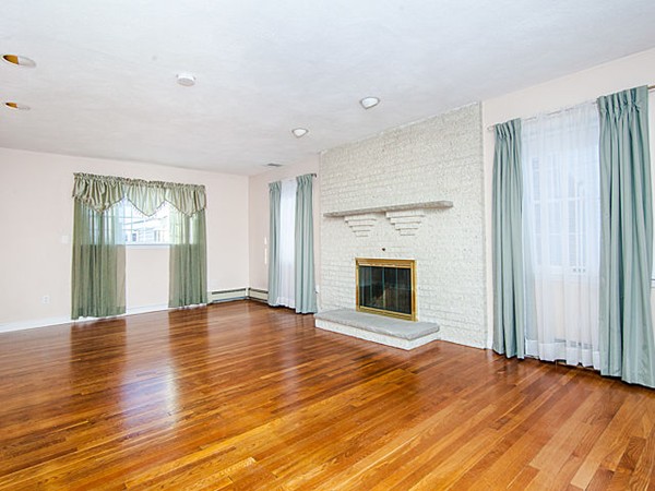 41 Lodge Road Newton, MA 02465 - Photo 24 of 25 an empty room with wooden floor fireplace and windows