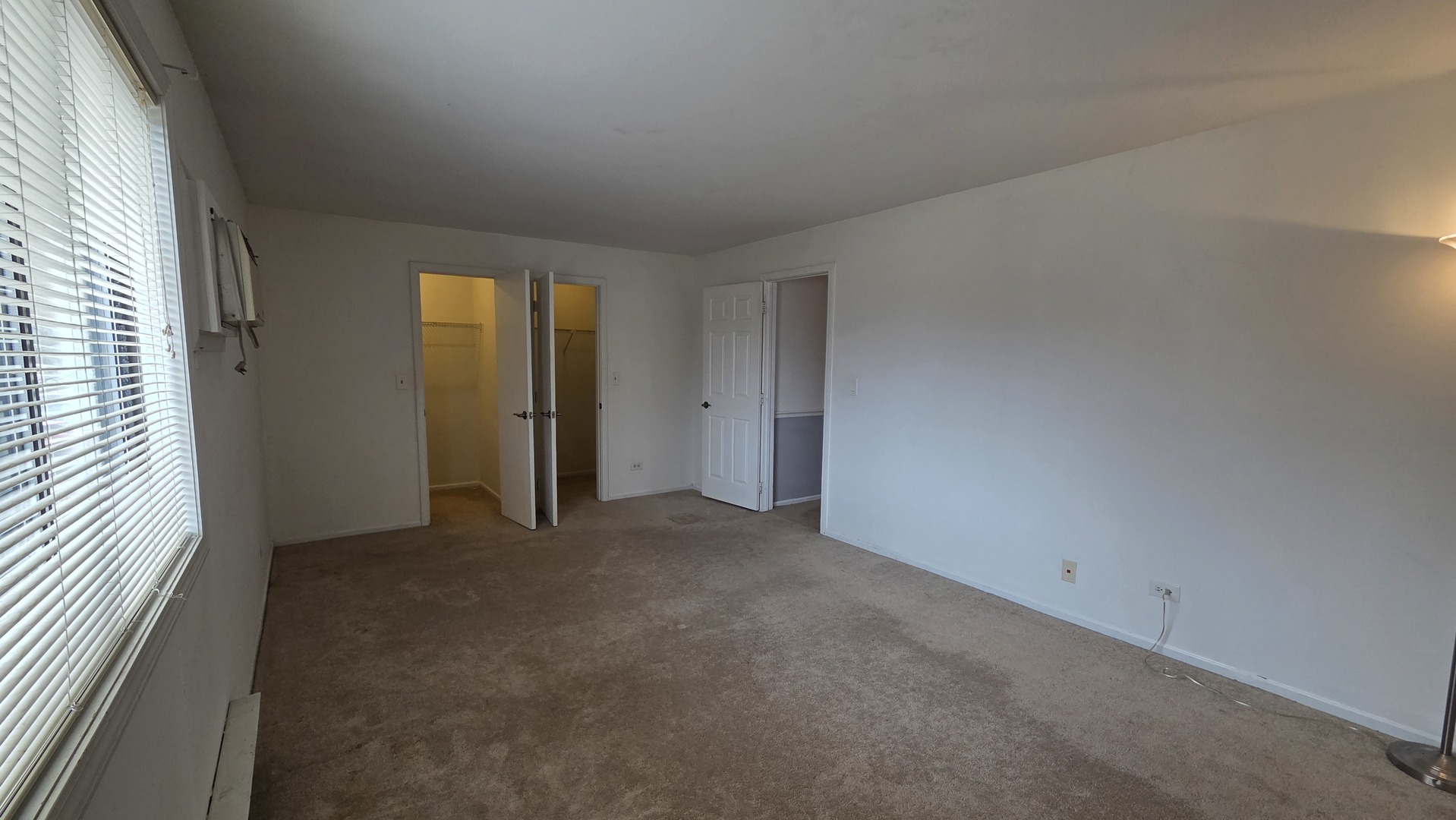 627 South Virginia Road, Unit 212 Crystal Lake, IL 60014 - Photo 10 of 15 an empty room with windows and closet