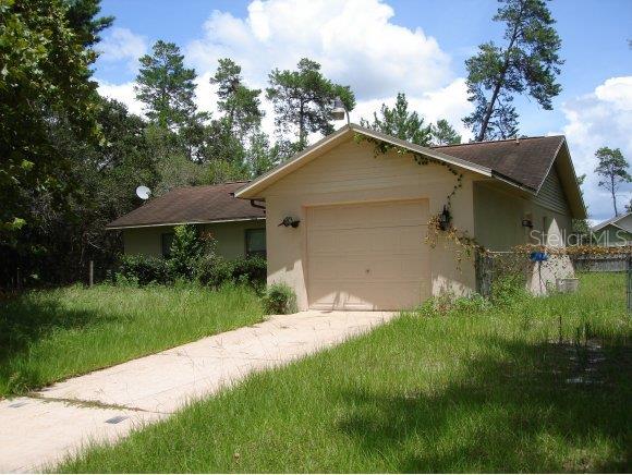 13625 Southwest 43rd Circle Ocala, FL 34473 - Photo 1 of 1 a front view of a house with garden