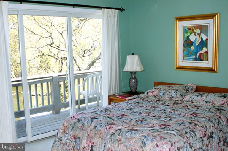 1421 Oak Bluff Road Edgewater, MD 21037 - Photo 18 of 30 a bedroom with a bed and a painting on the wall