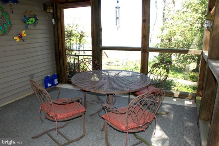 1421 Oak Bluff Road Edgewater, MD 21037 - Photo 19 of 30 a view of a dining room with furniture window and outside view