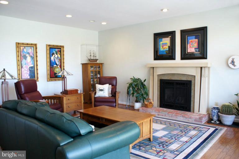 1421 Oak Bluff Road Edgewater, MD 21037 - Photo 21 of 30 a living room with furniture and a fireplace
