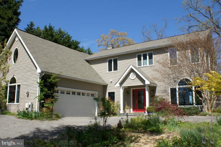1421 Oak Bluff Road Edgewater, MD 21037 - Photo 25 of 30 a front view of a house with garden