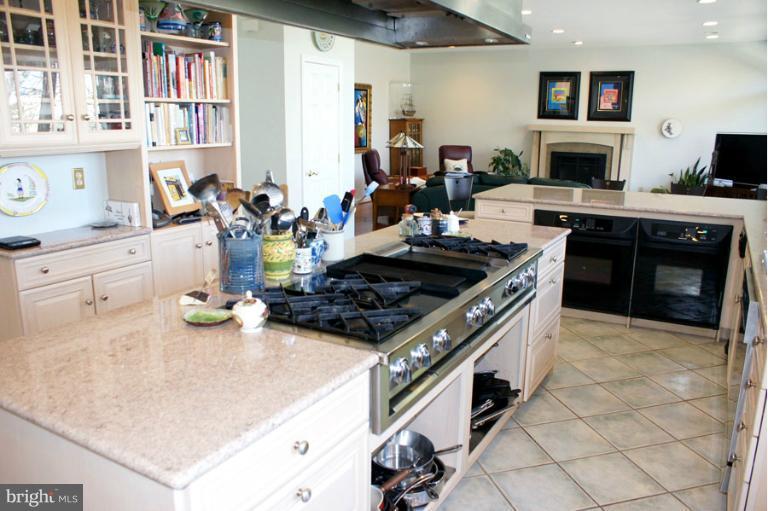 1421 Oak Bluff Road Edgewater, MD 21037 - Photo 27 of 30 a kitchen with stainless steel appliances granite countertop a stove and a white cabinets