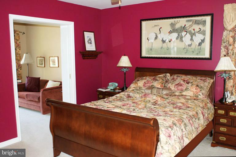 1421 Oak Bluff Road Edgewater, MD 21037 - Photo 29 of 30 a bed sitting in a bedroom and painting on the wall