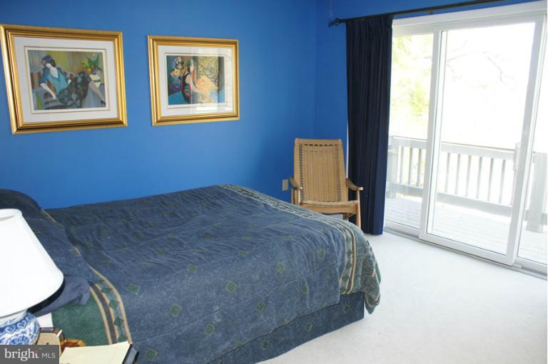1421 Oak Bluff Road Edgewater, MD 21037 - Photo 8 of 30 a bed sitting in a bedroom next to a window