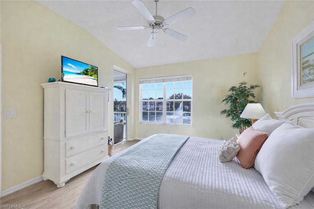 10801 Halfmoon Shoal Road, Unit 202 Estero, FL 34135 - Photo 9 of 45 (Virtual flooring upgrades) Primary Bedroom is light and bright with a private entrance to the patio and beautiful west facing views of the fountain and lake.