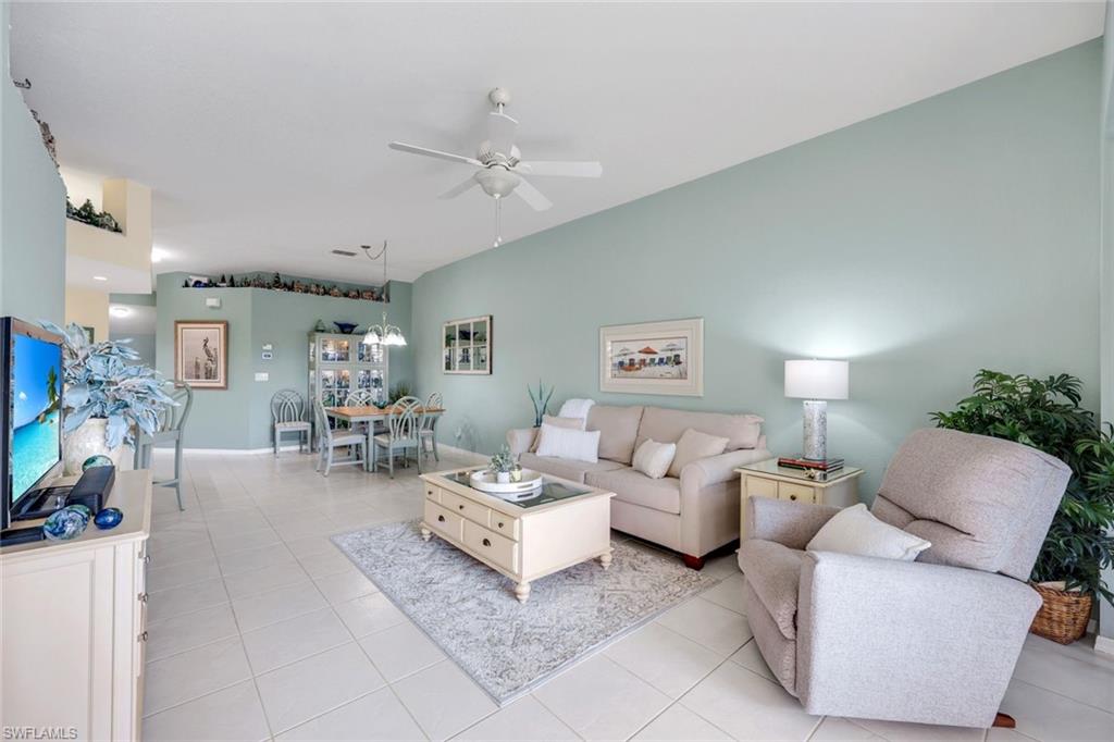 10801 Halfmoon Shoal Road, Unit 202 Estero, FL 34135 - Photo 43 of 45 Beautiful living room with dining area in a spacious open floor plan.