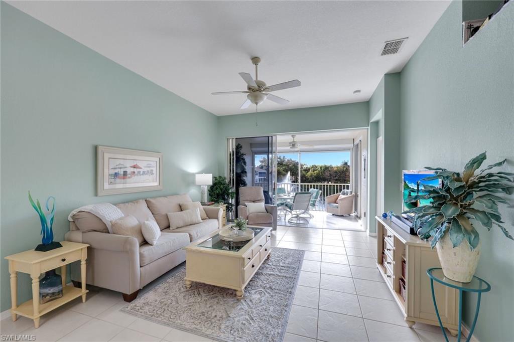 10801 Halfmoon Shoal Road, Unit 202 Estero, FL 34135 - Photo 16 of 45 Living room with gorgeous view of of the lake and fountains with a western facing view.