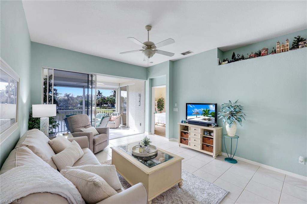 10801 Halfmoon Shoal Road, Unit 202 Estero, FL 34135 - Photo 18 of 45 Living room with gorgeous view of of the lake and fountains with a western facing view.