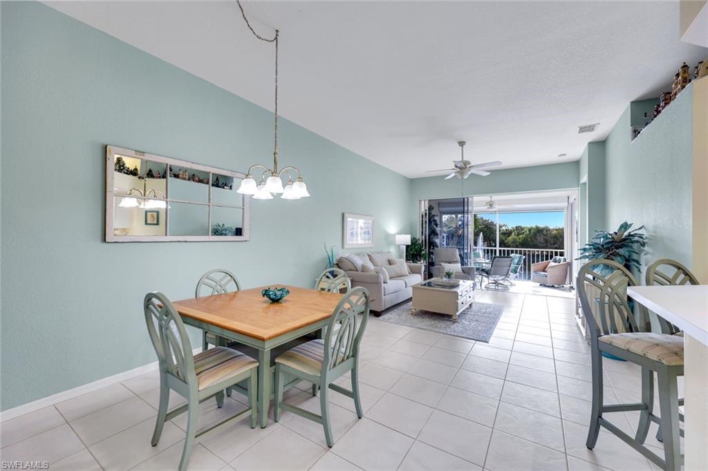 10801 Halfmoon Shoal Road, Unit 202 Estero, FL 34135 - Photo 44 of 45 Dining area, living room and counter seating at the kitchen bar in a spacious open floor plan.