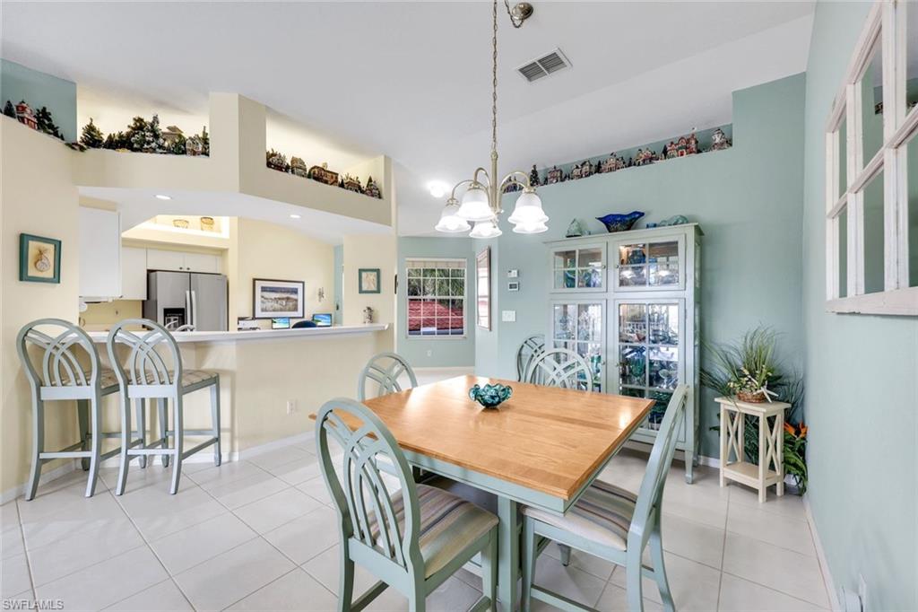 10801 Halfmoon Shoal Road, Unit 202 Estero, FL 34135 - Photo 45 of 45 Dining area, living room and counter seating at the kitchen bar in a spacious open floor plan.