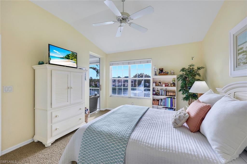 10801 Halfmoon Shoal Road, Unit 202 Estero, FL 34135 - Photo 23 of 45 Primary Bedroom is light and bright with a private entrance to the patio and beautiful west facing views of the fountain and lake.