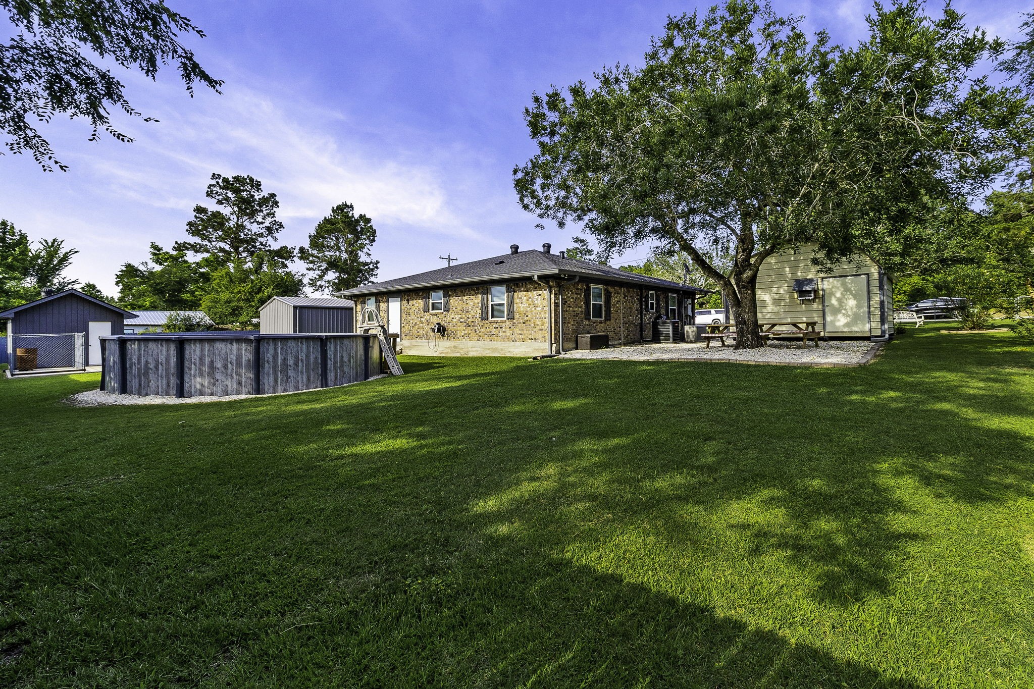 188 Huckleberry Road Onalaska, TX 77360 - Photo 33 of 49 a view of a house with a back yard