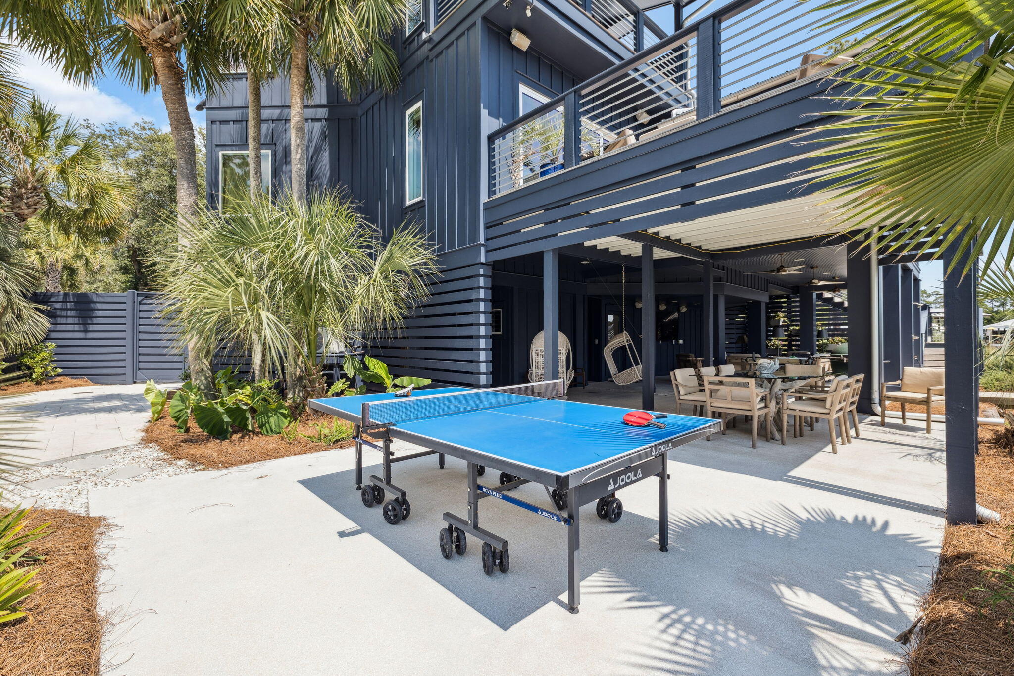 683 Eden Drive Santa Rosa Beach, FL 32459 - Photo 25 of 69 a view of a patio with a table and chairs under an umbrella