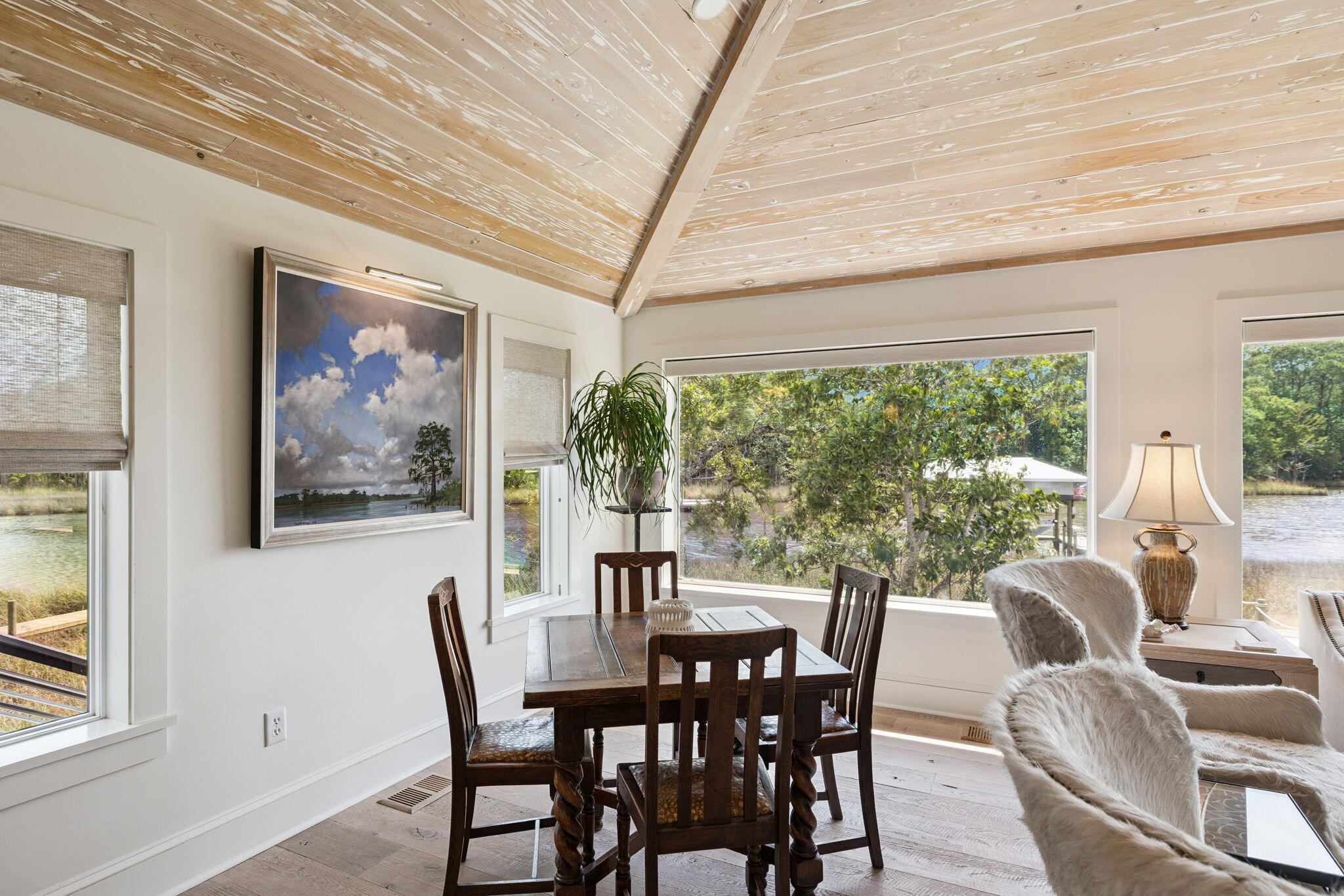 683 Eden Drive Santa Rosa Beach, FL 32459 - Photo 36 of 69 a view of a dining room with furniture large windows and wooden floor