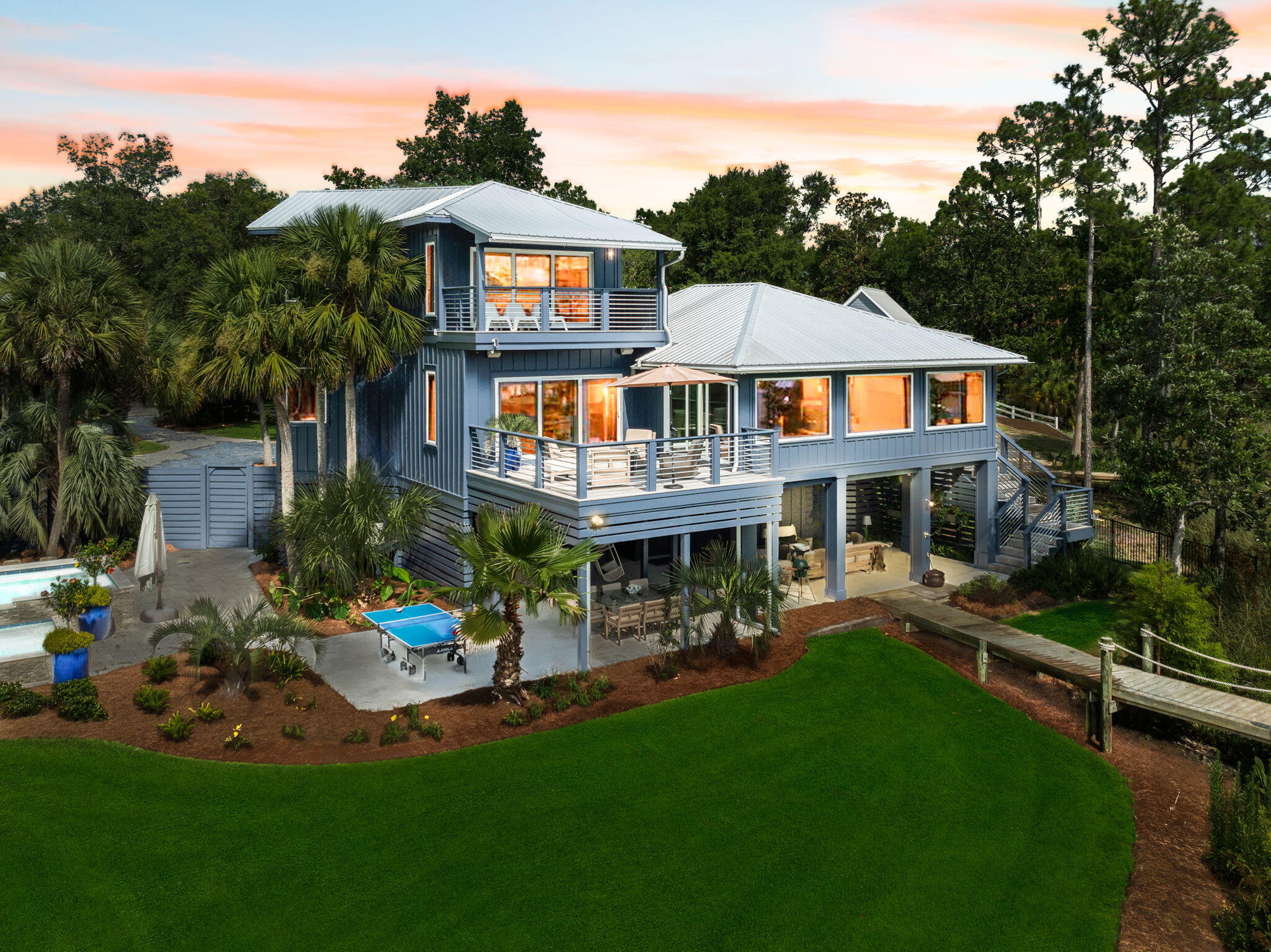 683 Eden Drive Santa Rosa Beach, FL 32459 - Photo 6 of 69 a front view of a house with a yard table and chairs