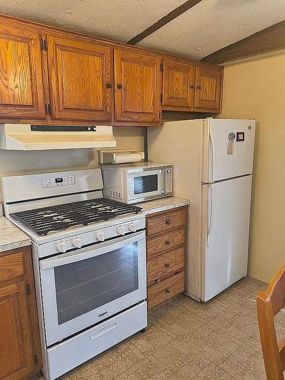 1250 Winn Road Bowie, TX 76230 - Photo 17 of 40 a kitchen with appliances cabinets and a sink