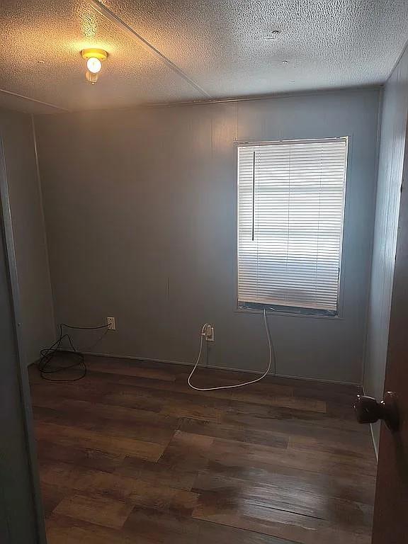 1250 Winn Road Bowie, TX 76230 - Photo 23 of 40 a room with a wooden floor and cabinets